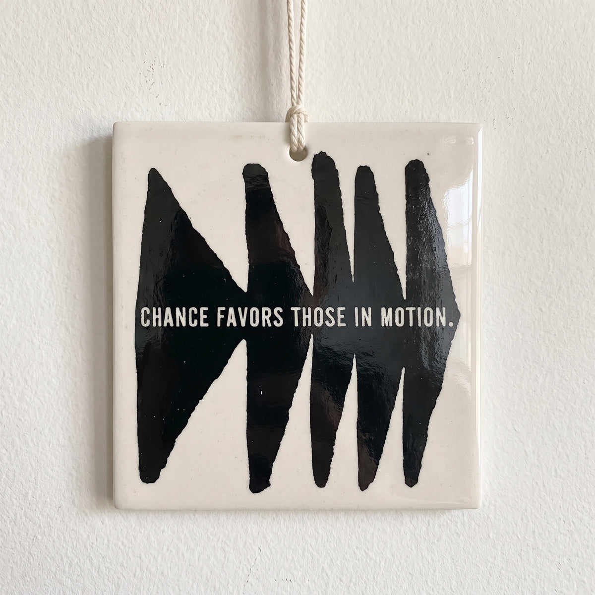 Porcelain wall tag: CHANCE FAVORS THOSE IN MOTION.