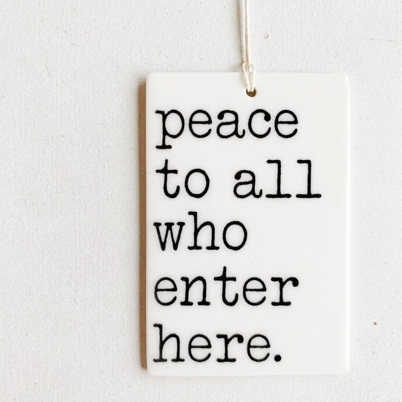 peace to all who enter here ceramic wall tag