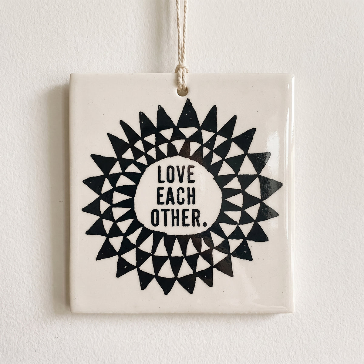 Porcelain wall tag: LOVE 
EACH 
OTHER.