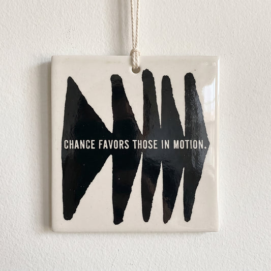 Porcelain wall tag: CHANCE FAVORS THOSE IN MOTION.