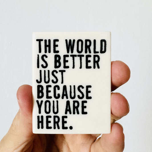 the world is better quote ceramic magnet 1.69" w x 2.19" h