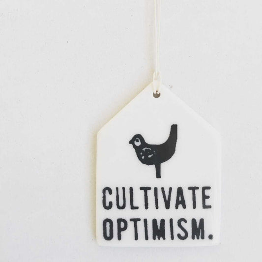 cultivate optimism ceramic wall tag