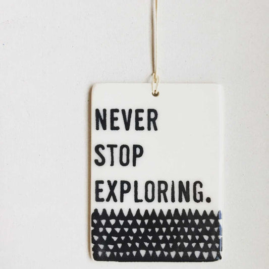 never stop exploring ceramic wall tag