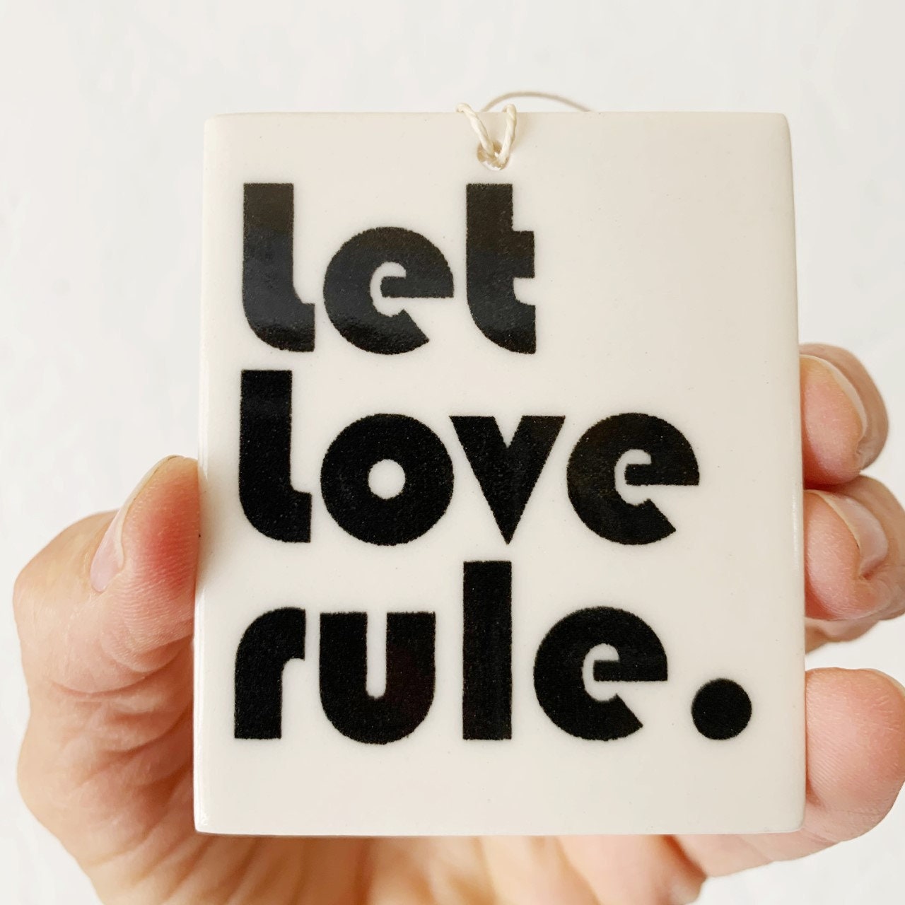 porcelain wall tag screenprinted text let love rule.